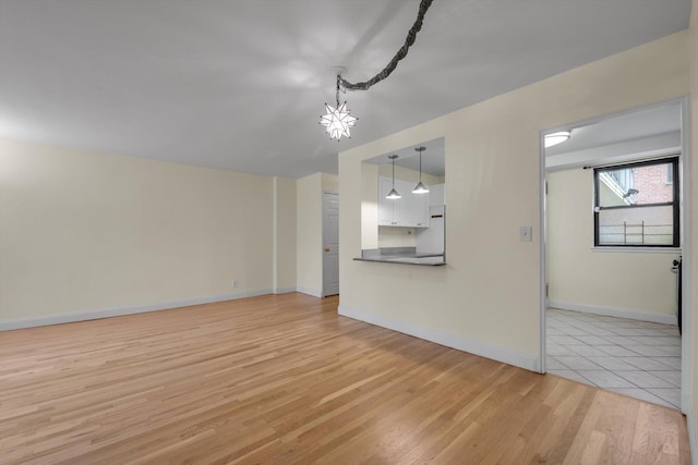 4705 Henry Hudson Pkwy W Unit 1J, Bronx, NY 10471 - unfurnished living room featuring light wood-style floors and baseboards