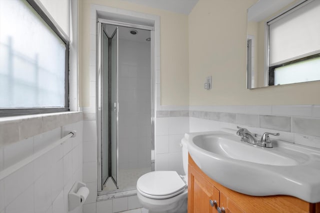 4705 Henry Hudson Pkwy W Unit 1J, Bronx, NY 10471 - bathroom with tile walls, vanity, a stall shower, and wainscoting
