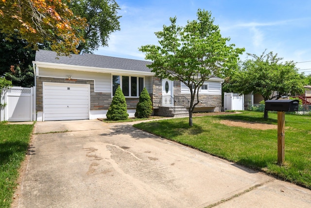 43 Walton St, Brentwood, NY 11717 - view of front of house with stone siding, a garage, concrete driveway, and a gate