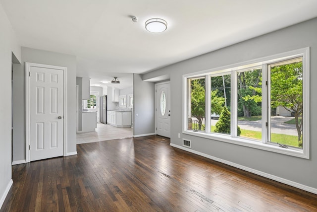 43 Walton St, Brentwood, NY 11717 - unfurnished living room featuring baseboards and hardwood / wood-style floors