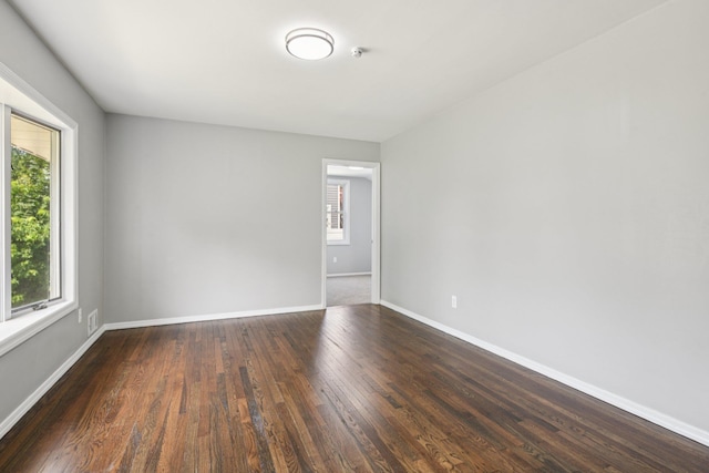43 Walton St, Brentwood, NY 11717 - spare room featuring dark wood-type flooring and baseboards
