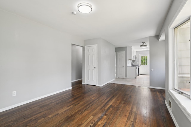 43 Walton St, Brentwood, NY 11717 - unfurnished living room with hardwood / wood-style flooring and baseboards