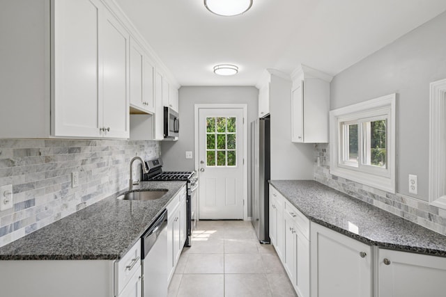 43 Walton St, Brentwood, NY 11717 - kitchen featuring stainless steel appliances, tasteful backsplash, white cabinets, and light tile patterned flooring