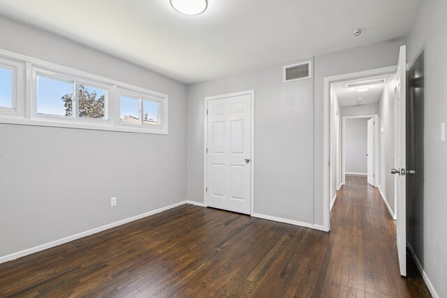 43 Walton St, Brentwood, NY 11717 - unfurnished bedroom featuring dark wood finished floors and baseboards