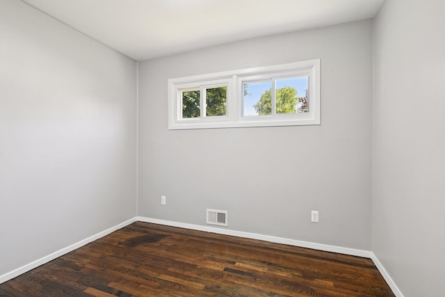 43 Walton St, Brentwood, NY 11717 - spare room with baseboards and dark wood-type flooring