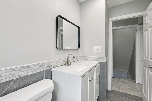 43 Walton St, Brentwood, NY 11717 - half bathroom featuring tile walls, vanity, and wainscoting