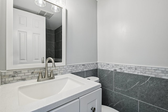 43 Walton St, Brentwood, NY 11717 - bathroom with vanity, a wainscoted wall, and tile walls