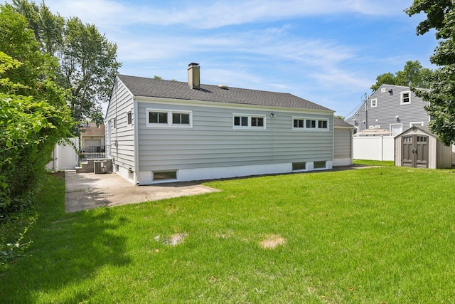 43 Walton St, Brentwood, NY 11717 - back of property featuring a storage unit, a patio, and a chimney