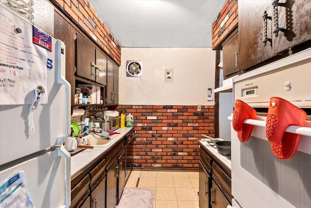51-23 71st St, Woodside, NY 11377 - kitchen featuring white appliances, dark brown cabinetry, light tile patterned flooring, and light countertops
