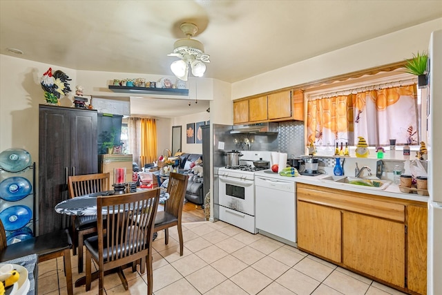 51-23 71st St, Woodside, NY 11377 - kitchen featuring white appliances, under cabinet range hood, ceiling fan, light countertops, and light tile patterned floors