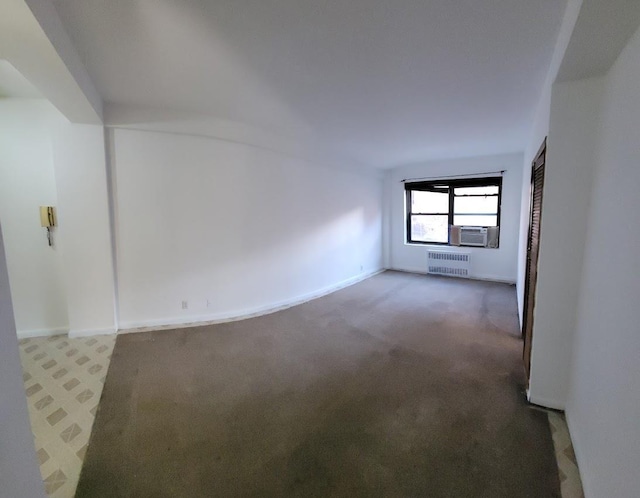99-60 63rd Rd Unit 1B, Rego Park, NY 11374 - carpeted spare room with radiator heating unit and baseboards