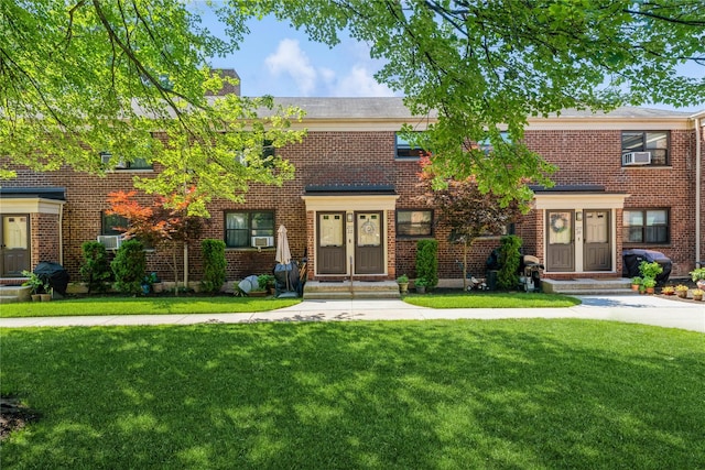 217-22 73rd Ave Upper, Upper, Oakland Gardens, NY 11364 - townhome / multi-family property with a front lawn, brick siding, cooling unit, and a chimney
