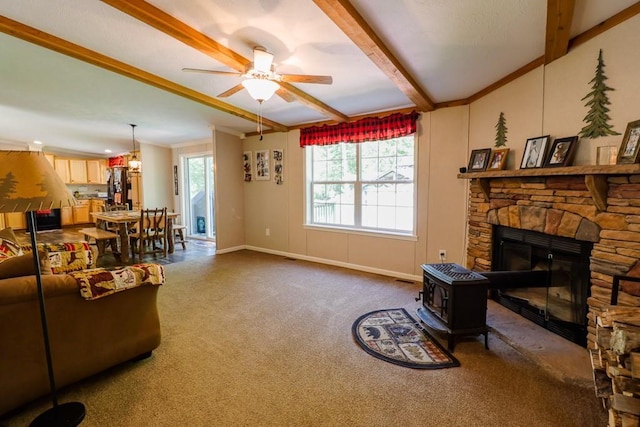 101 W Peenpack Trl, Sparrowbush, NY 12780 - living area with dark colored carpet, beamed ceiling, ceiling fan, and a wood stove