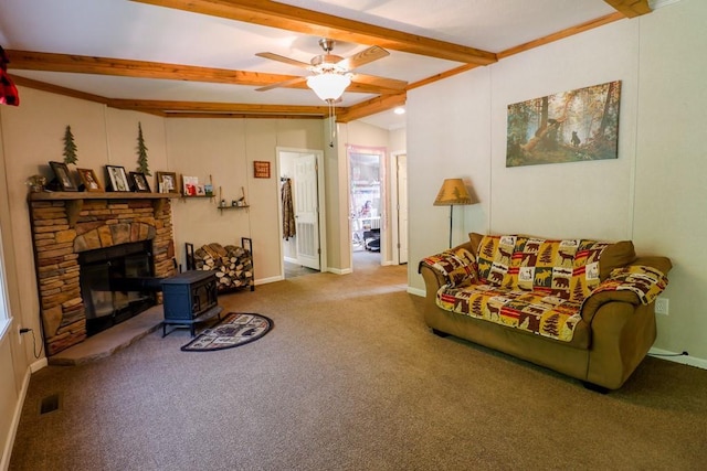 101 W Peenpack Trl, Sparrowbush, NY 12780 - living room with beamed ceiling, carpet flooring, a ceiling fan, and a wood stove