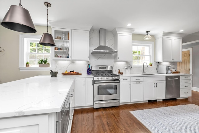 550 Nassau Blvd, West Hempstead, NY 11552 - kitchen with stainless steel appliances, wall chimney range hood, white cabinetry, dark wood finished floors, and tasteful backsplash