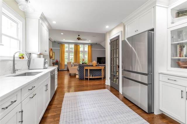 550 Nassau Blvd, West Hempstead, NY 11552 - kitchen featuring appliances with stainless steel finishes, white cabinetry, dark wood-type flooring, decorative backsplash, and recessed lighting