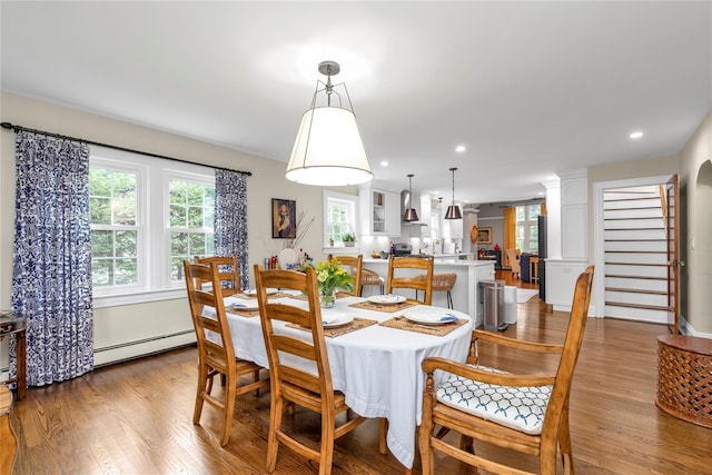 550 Nassau Blvd, West Hempstead, NY 11552 - dining space featuring a baseboard heating unit, wood finished floors, recessed lighting, and stairway