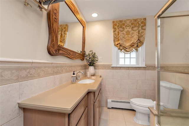 550 Nassau Blvd, West Hempstead, NY 11552 - bathroom with tile walls, baseboard heating, tile patterned floors, vanity, and wainscoting