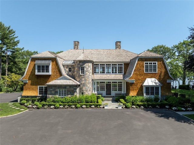 12 N Rd, Laurel Hollow, NY 11771 - shingle-style home with stone siding, a chimney, and a gambrel roof