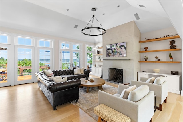 12 N Rd, Laurel Hollow, NY 11771 - living area featuring light wood-type flooring, a fireplace, and high vaulted ceiling