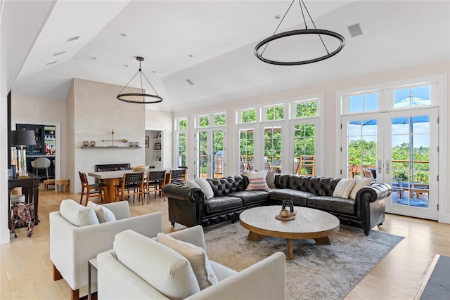 12 N Rd, Laurel Hollow, NY 11771 - living area with plenty of natural light, high vaulted ceiling, and light wood-style flooring