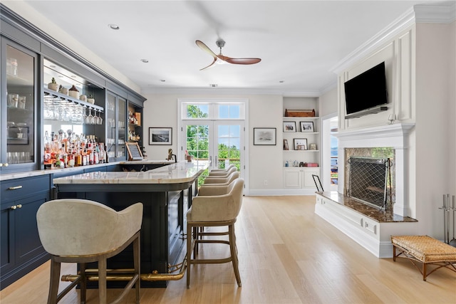12 N Rd, Laurel Hollow, NY 11771 - indoor bar with a ceiling fan, a fireplace, light wood finished floors, ornamental molding, and built in shelves