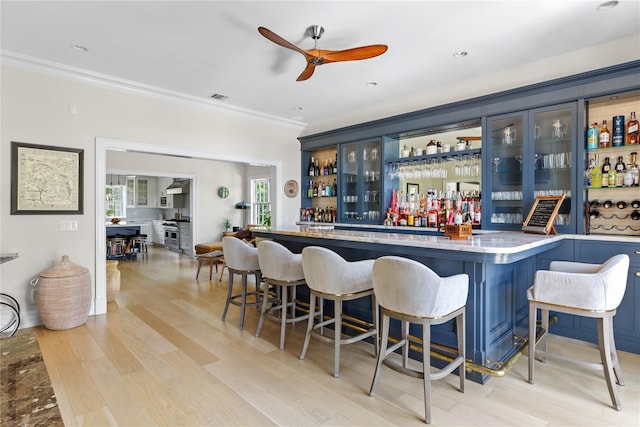 12 N Rd, Laurel Hollow, NY 11771 - indoor dry bar with light wood-style flooring, crown molding, and a ceiling fan