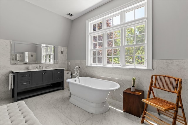 12 N Rd, Laurel Hollow, NY 11771 - bathroom featuring tile walls, a freestanding bath, vanity, healthy amount of natural light, and wainscoting
