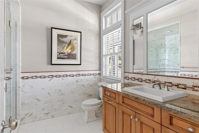 12 N Rd, Laurel Hollow, NY 11771 - bathroom featuring vanity, tile walls, wainscoting, tile patterned flooring, and a shower with door