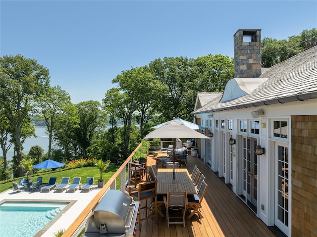 12 N Rd, Laurel Hollow, NY 11771 - wooden terrace with outdoor dining area, grilling area, an outdoor pool, a yard, and view of scattered trees