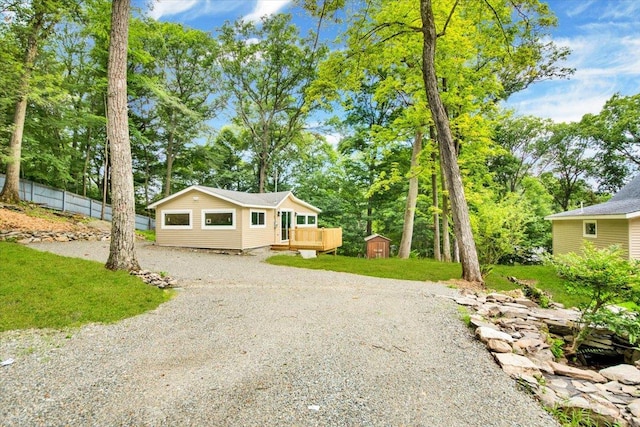 10 Pioneer Trl, Monroe, NY 10950 - view of front of home with a storage unit, driveway, and a wooden deck