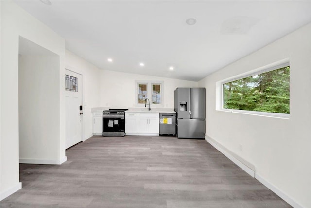 10 Pioneer Trl, Monroe, NY 10950 - kitchen featuring stainless steel appliances, light countertops, white cabinetry, light wood-style floors, and recessed lighting