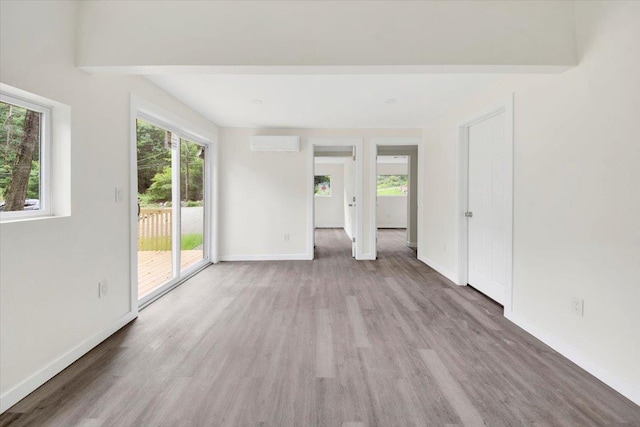 10 Pioneer Trl, Monroe, NY 10950 - empty room with a wall unit AC and wood finished floors