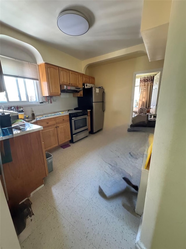 33-42 150th St, Flushing, NY 11354 - kitchen featuring under cabinet range hood, appliances with stainless steel finishes, and brown cabinets