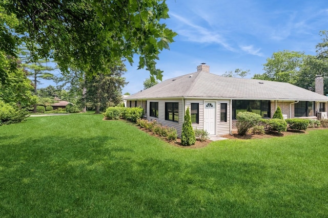 2 Foxwood Rd, Kings Point, NY 11024 - back of house featuring a chimney and a lawn