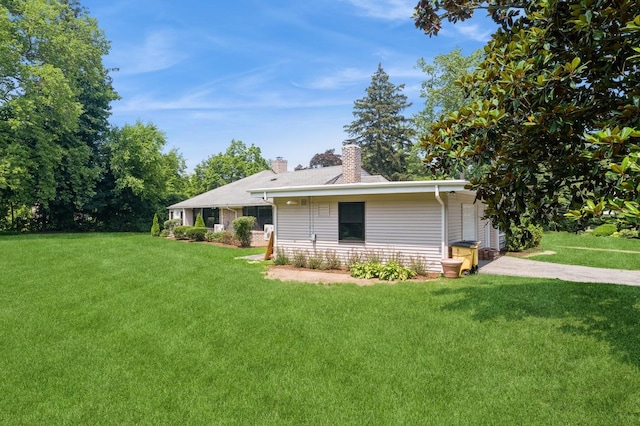 2 Foxwood Rd, Kings Point, NY 11024 - back of property featuring a chimney and a lawn