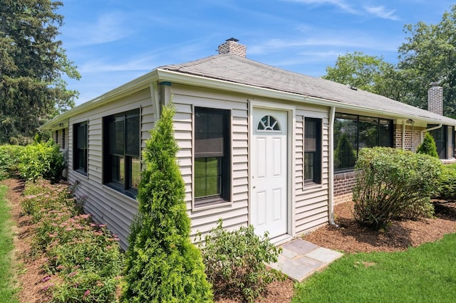 2 Foxwood Rd, Kings Point, NY 11024 - view of side of home with a chimney and brick siding