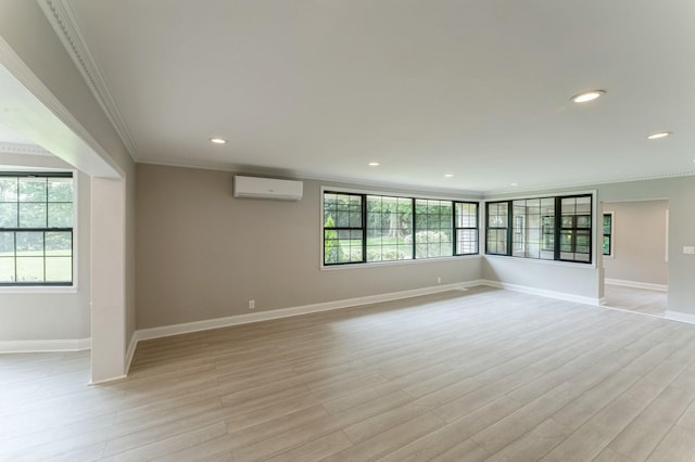 2 Foxwood Rd, Kings Point, NY 11024 - empty room with a wall unit AC, ornamental molding, healthy amount of natural light, light wood finished floors, and recessed lighting