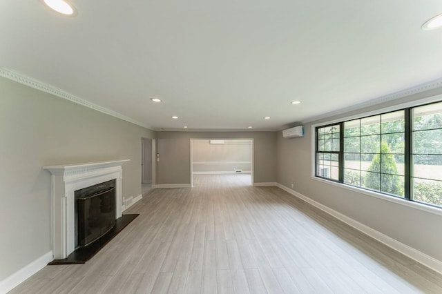 2 Foxwood Rd, Kings Point, NY 11024 - unfurnished living room with a wall mounted air conditioner, light wood finished floors, recessed lighting, a fireplace with raised hearth, and crown molding
