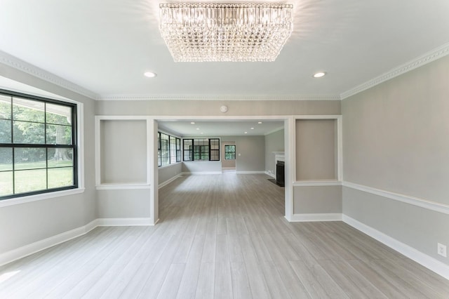 2 Foxwood Rd, Kings Point, NY 11024 - unfurnished room featuring a chandelier, healthy amount of natural light, light wood-style flooring, a fireplace, and recessed lighting