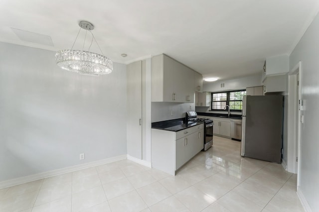 2 Foxwood Rd, Kings Point, NY 11024 - kitchen featuring stainless steel appliances, dark countertops, a chandelier, and light tile patterned flooring