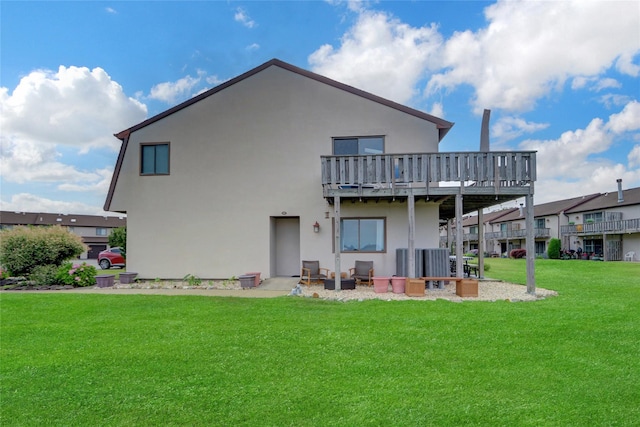 1 Anchorage Way Unit 301, Freeport, NY 11520 - back of property with a lawn, stucco siding, and a deck