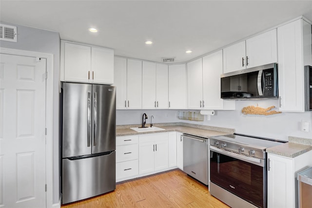 1 Anchorage Way Unit 301, Freeport, NY 11520 - kitchen featuring stainless steel appliances, light countertops, white cabinetry, and recessed lighting