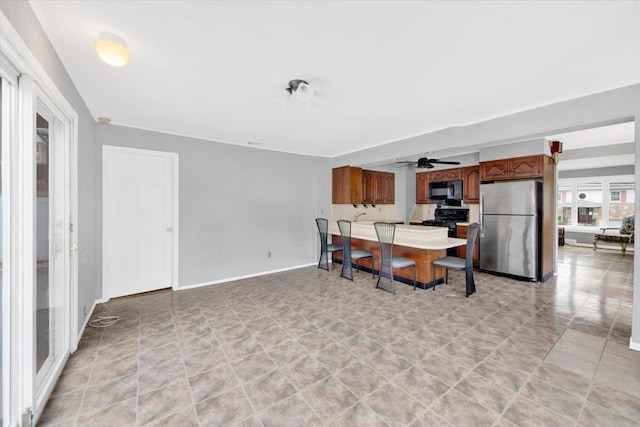 107 Croydon Rd, Yonkers, NY 10710 - kitchen with black appliances, brown cabinetry, ceiling fan, and light countertops