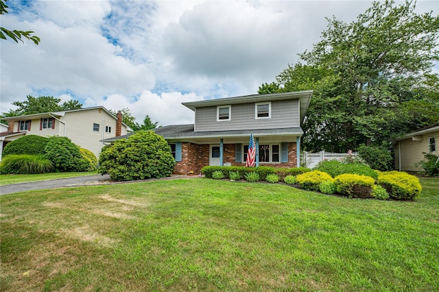145 Fifty Acre Rd S, Smithtown, NY 11787 - traditional-style house with a porch, brick siding, and driveway
