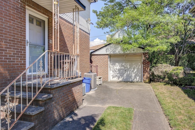 7015 170th St, Fresh Meadows, NY 11365 - view of side of property with brick siding, an outdoor structure, and a detached garage