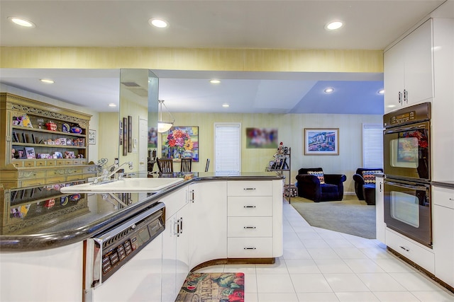 7015 170th St, Fresh Meadows, NY 11365 - kitchen featuring white dishwasher, dark countertops, light tile patterned floors, light colored carpet, and recessed lighting