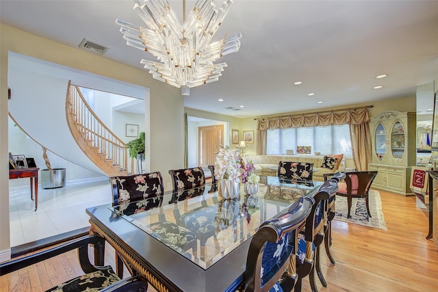 7015 170th St, Fresh Meadows, NY 11365 - dining room with a chandelier, stairs, light wood-type flooring, and recessed lighting