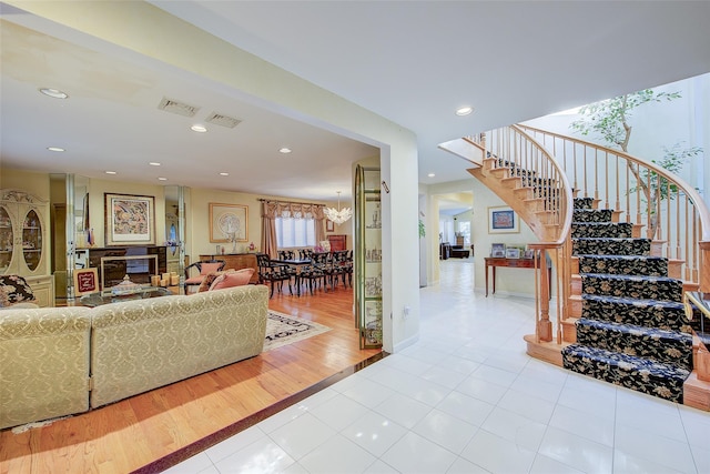 7015 170th St, Fresh Meadows, NY 11365 - stairway featuring tile patterned flooring, recessed lighting, and a chandelier