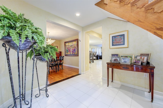 7015 170th St, Fresh Meadows, NY 11365 - hallway with a chandelier and tile patterned flooring